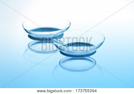 Contact lenses with reflections on blue background