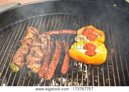 Delicious french sausages and meat on the barbecue grill