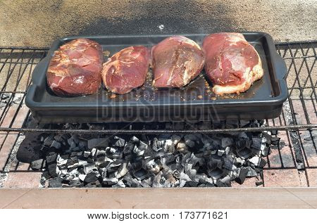 Raw duck fillet on the iron grill