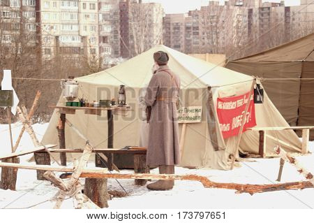 26.02.2017. Saint-Petersburg. Military-historical festival. Reenactment. Old Soviet military equipment and uniforms. Military tent a fire a samovar.