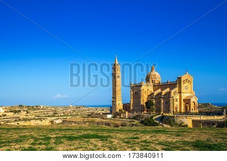 Gozo Malta - The Basilica of the National Shrine of the Blessed Ta' Pinu early at the morning with clear blue sky on a summer day