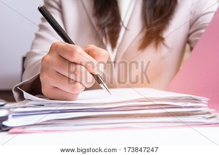 business women signing contract document on office desk