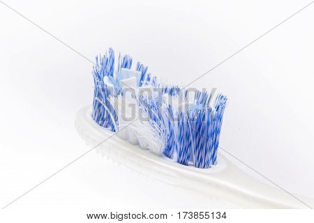 Close up of an old toothbrush on white background