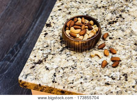 Nuts Concept, Assorted Nuts, Nuts on kitchen countertop, Yellow and brown nuts, Different types of nuts,