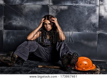 sexy female miner worker with pickaxe, in coveralls over his naked body. erotic industry concept.
