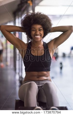 young fit african american woman doing sit ups in fitness studio at the gym.Abdominal exercises Sit up