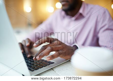 Hands of businessman or designer typing on l aptop