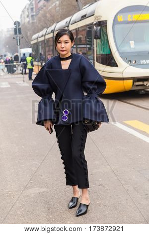 MILAN ITALY - FEBRUARY 23: Fashionable woman poses outside Fendi fashion show during Milan Women's Fashion Week on FEBRUARY 23 2017 in Milan.