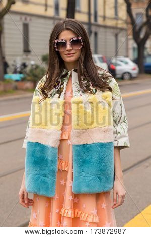MILAN ITALY - FEBRUARY 23: Fashionable woman poses outside Fendi fashion show during Milan Women's Fashion Week on FEBRUARY 23 2017 in Milan.