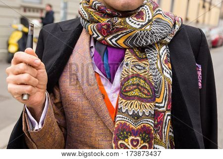 MILAN ITALY - FEBRUARY 23: Detail of a fashionable man outside Fendi fashion show during Milan Women's Fashion Week on FEBRUARY 23 2017 in Milan.