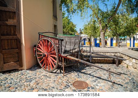 PORT AVENTURA/ SPAIN - MAY 11, 2015. Old wooden wagon with red wheels in the Far West area of theme park Port Aventura in city Salou, Spain.