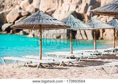 Beach chairs on exotic tropical white sandy beach