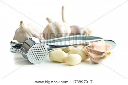 Garlic and garlic press isolated on white background.