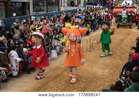 Large figures in Cologne's rose monday parade followed by parade vehicles - Participants of the rose monday parade in cologne on February 27, 2017
