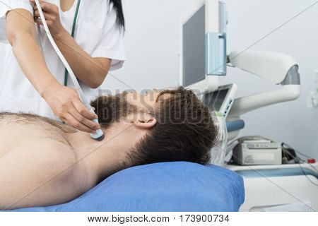 Patient Undergoing Ultrasound Of Thyroid From Doctor