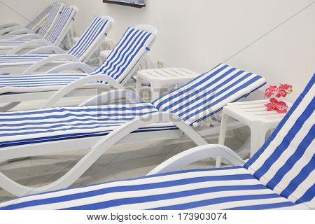 Chaise-longues in a fitness-hall, spa or so on
