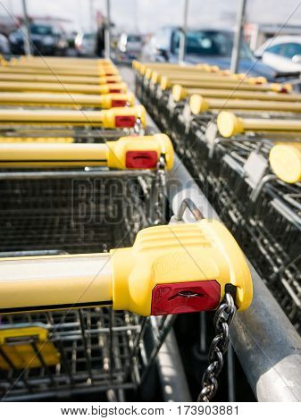 Shopping carts stay on parking locking system on the coin.