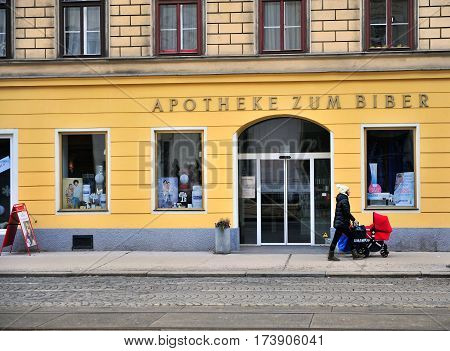 VIENNA AUSTRIA - FEBRUARY 11: Undefined person with a baby stroller in the street of Vienna on February 11 2017. Vienna is a capital and largest city of Austria.