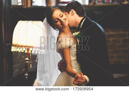 Groom Kisses Bride's Neck Dancing With Her In Vintage Hall