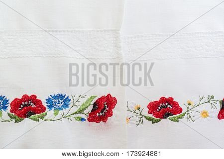 Embroidered floral pattern on a white linen towel