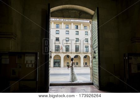 Bride, about to marry, waiting at the door the arrival of the groom.