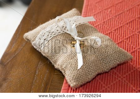 Two wedding rings tied in a sackcloth pad