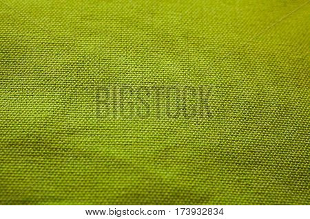 Green fabric texture. Cloth background. Close up view of green fabric texture and background. Abstract background and texture for designers.