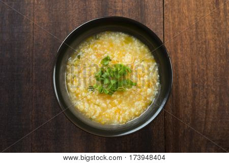 Top view congee bowl on wooden table background.
