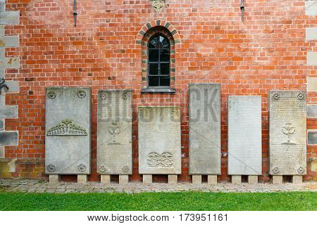 Haseldorf Germany-June 24 2011:Church of St. Gabriel. old tombstones with inscriptions from the walls of the old Church