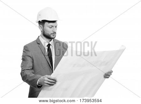 Visioning future. Studio shot of a professional male architect wearing hardhat examining building blueprints isolated on white professionalism occupation job career experience engineering concept