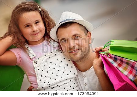 Happy father with daughter have a successful day of shopping