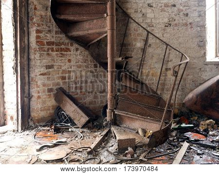 Rusty old staircase spiral. A lot of garbage. The brick walls of the tower