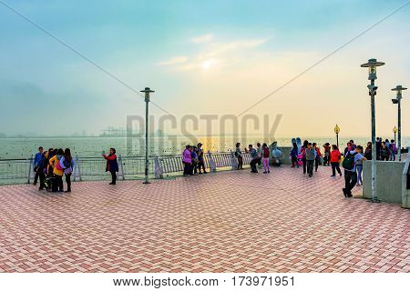 TAIPEI TAIWAN - JANUARY 05: People on Fisherman's wharf pier during sunset in the tamsui area of Taipei on January 05 2017 in Taipei
