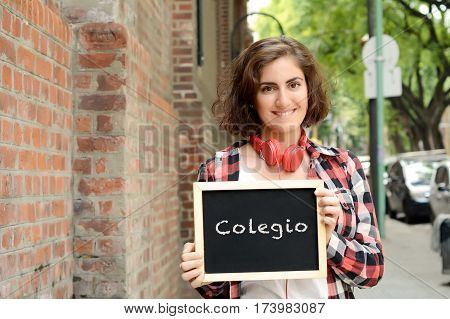 Young beautiful woman holding chalkboard with text 