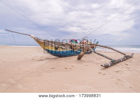 Wooden fishing boat with a fishing tackle at the sealandscape.