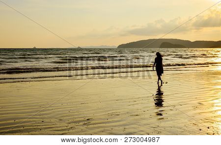 Single Young Woman On Beach When Sunset