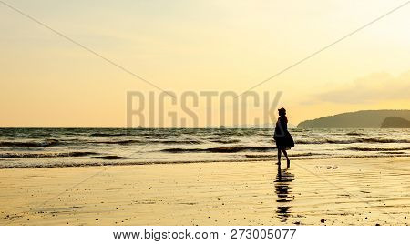 Single Young Woman On Beach When Sunset