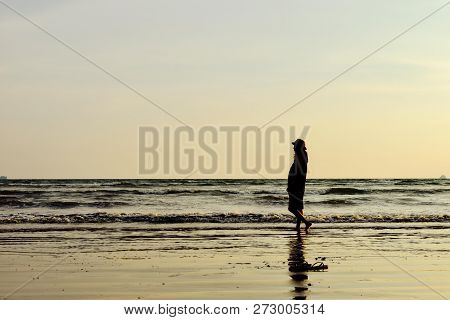 Single Young Woman On Beach When Sunset