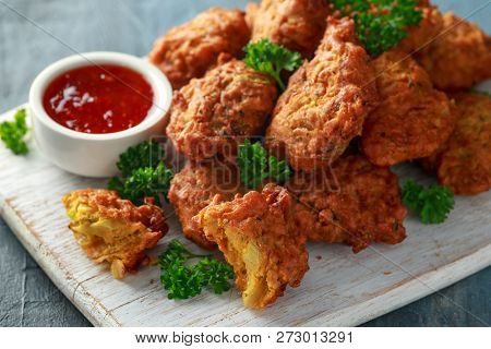 Crispy Onion Bhajis With Sweet Chilli Sauce On White Wooden Board