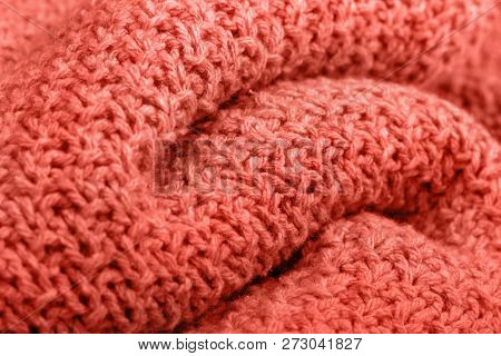 Knitted Fabric Texture Living Corel Color. Selective Focus. Trendy Concept Color Of The Year.
