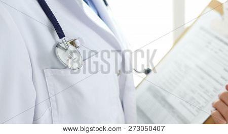 Female Doctor Using Medical Form On Clipboard Closeup.  Physicianat Work In Hospital Or Clinic. Heal
