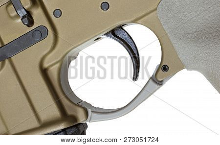 Trigger On An Ar-15 That Is Brown Isolated On White