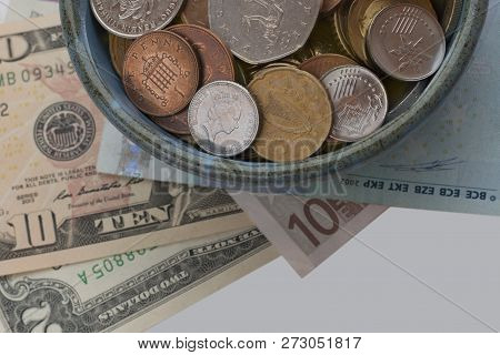 Cup Of Plenty. Treasure Concept. Coins And Banknotes From Different Countries. Symbol Of Wealth And 