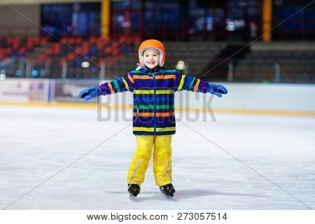 Child Skating On Indoor Ice Rink. Kids Skate.