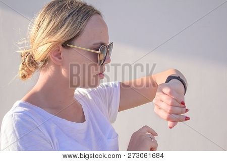 Sports Girl Is Switching On Her Fitbit Bracelet Tracker Before Training