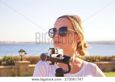 Young Attractive Man Films A Travel Video Using The Steadycam Gimbal And A Phone