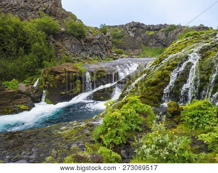 Beautiful Valley Gjain With Colorful Lava Rocks, Lush Green Moss And Vegetation And Blue Water With 