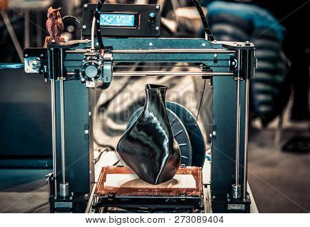 3d Printer Printing A Model In The Form Of Black Vase Close-up.