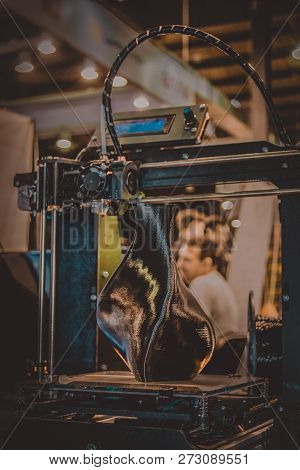 3d Printer Printing A Model In The Form Of Black Vase Close-up.