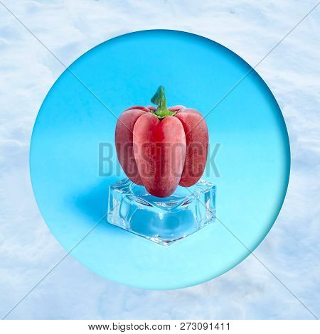 Frozen Red Pepper On Ice Cube In Snow Frame. Creative Concept: Quickly Frozen Fruits And Vegetables 
